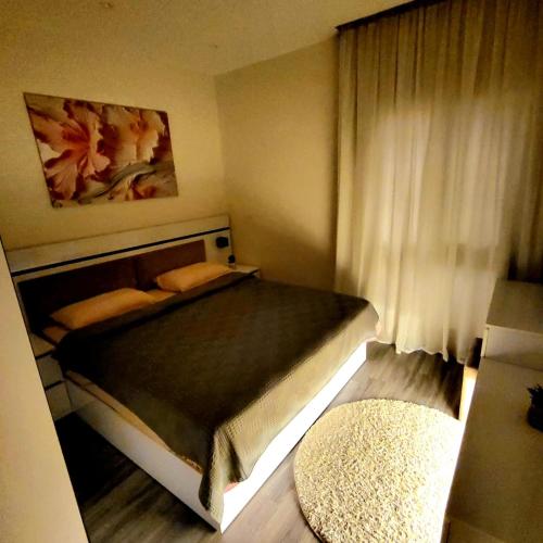 a bedroom with a large bed with a window at Madinaty Cozy studio at Privado in New cairo