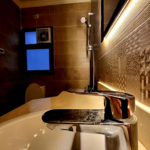 a bathroom with a bath tub and a sink at Madinaty Cozy studio at Privado in New cairo