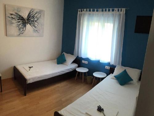 a small room with two beds and a window at Apartment Nikola M in Bol