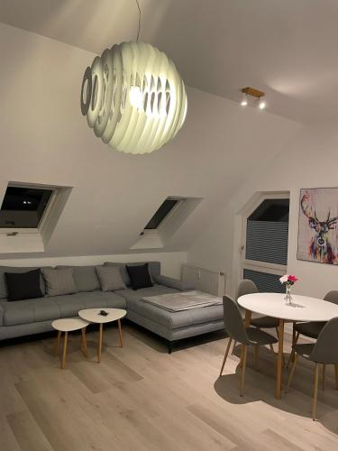 a living room with a couch and a table at Auszeit Offenburg in Offenburg