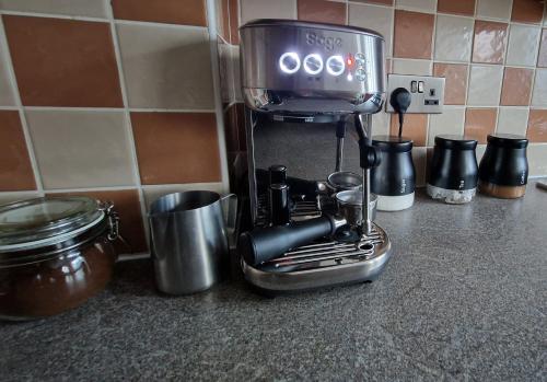 a coffee maker sitting on top of a kitchen counter at 3-Bedroom Family Holiday Home in Skegness