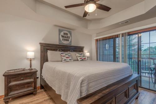 a bedroom with a bed and a ceiling fan at 2BR Village At Indian Point 604 near SDC-Free Tickets Daily up to $500 Value) in Branson