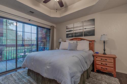 a bedroom with a bed and a large window at 2BR Village At Indian Point 705 near SDC-Free Tickets Daily up to $500 Value in Branson