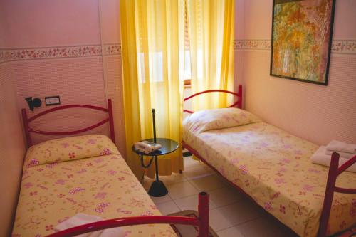 a small room with two beds and a window at Hotel Letizia in Orte