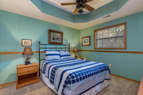a bedroom with a bed and a ceiling fan at 2BR Village At Indian Point 1005 near SDC-Free Tickets Daily up to $500 Value in Branson