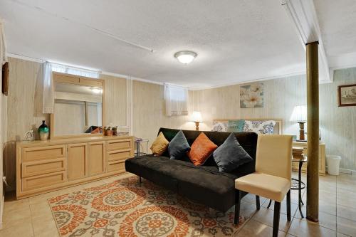 a living room with a couch and a kitchen at Super Cute & Cool Home with 65Inch TV 2Baths 4 Bedrooms 2King Beds BBQ Grill Fenced Backyard in Ferndale