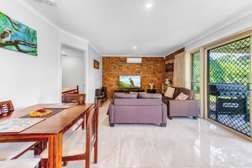 a living room with a couch and a table at Kookaburra Cottage in Montville