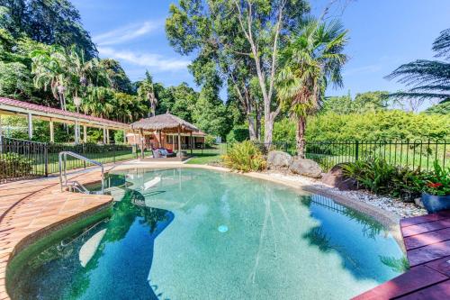 a swimming pool in a backyard with a gazebo at Kookaburra Cottage in Montville