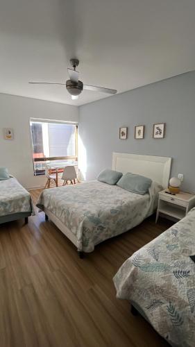a bedroom with two beds and a ceiling fan at Alto Buenos Aires in Buenos Aires