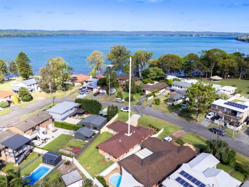 an aerial view of a village next to the water at The Sailor's Haven in Mannering Park