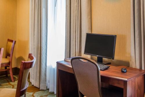 a room with a desk with a computer on it at MainStay Suites Grand Island in Grand Island