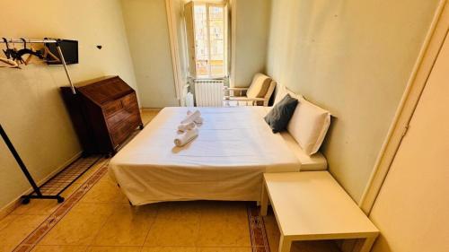 a small room with a bed and a bench in it at apt via cernaia rome center in Rome