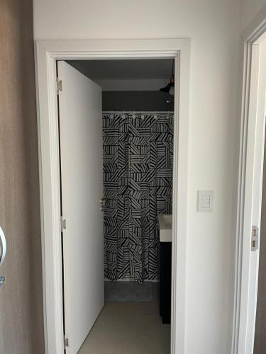 a door leading to a bathroom with a zebra print wall at Roma in Belén de Escobar