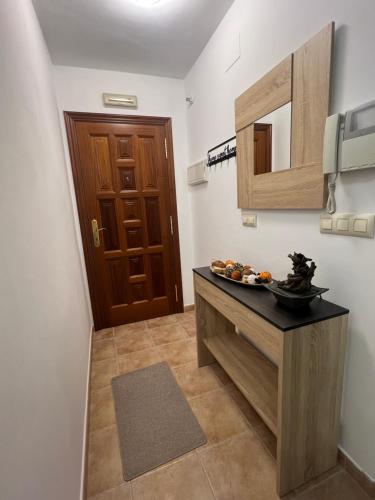 a small kitchen with a counter and a door at Sweet Floor in Negreira
