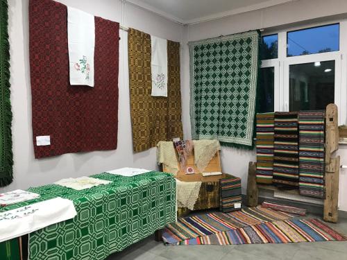 a room with blankets and blinds on a wall at Domek Walentinki in Rogacze