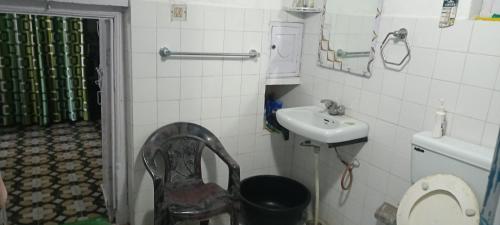 a small bathroom with a sink and a toilet at Eja Homestay Falsima in Almora