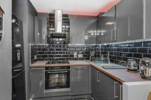 a kitchen with a stove and a counter top at ABBAccommodation in London