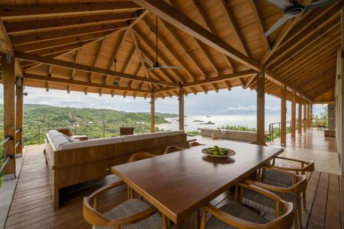 a living room with a wooden table and chairs at Casa Queña, in the heart of Mazunte in Mazunte