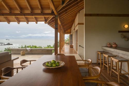 a dining room with a table with a bowl of fruit at Casa Queña, in the heart of Mazunte in Mazunte