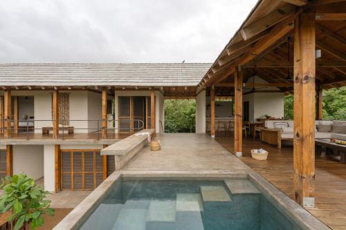 an external view of a house with a swimming pool at Casa Queña, in the heart of Mazunte in Mazunte