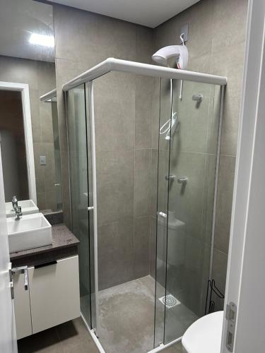 a bathroom with a shower and a sink at Charmoso Loft em Resort in Xangri-lá