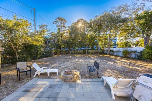 a patio with chairs and a fire pit at Dazzling Centrally Located Ocean View w 2 Kings, Huge Private Yard, 2 Decks, Firepit, BBQ in Myrtle Beach