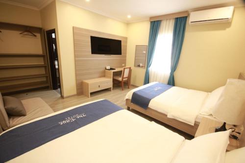 Ένα ή περισσότερα κρεβάτια σε δωμάτιο στο The Caye Hotel San Pedro