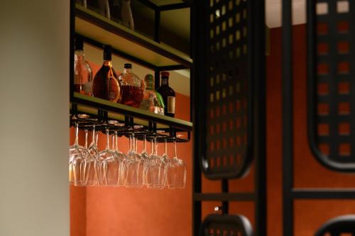 a row of wine glasses on a shelf in a bar at BHB Boutique House in Macedo de Cavaleiros