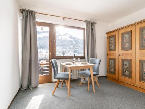 a dining room with a table and chairs and a window at Brixen Alpin Living Top 9 und 10 in Brixen im Thale