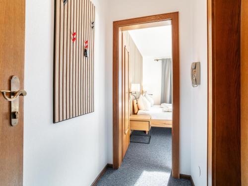 an open door to a room with a bedroom at Brixen Alpin Living Top 9 und 10 in Brixen im Thale