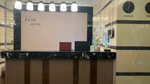 a counter in a store with clocks on the wall at Vera Hotel in Angeles