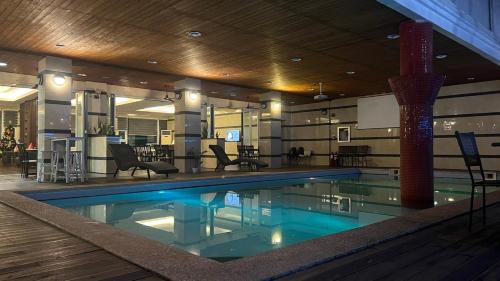 a large swimming pool in a hotel room at Vera Hotel in Angeles