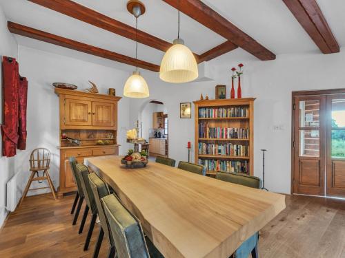 a dining room with a large wooden table and chairs at Villa in Czechia with Heated Pool & Mountain Views in Vidochov