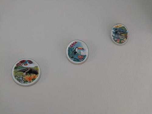 four plates hanging on a white wall at Palmenhaus in Pomerode