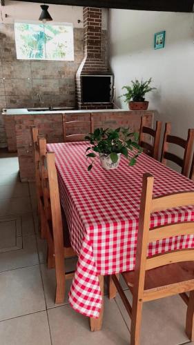 a dining room table with a red and white checkered table cloth at Palmenhaus in Pomerode