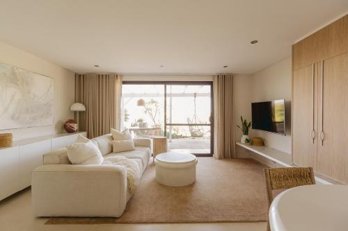 a living room with a couch and a table at Scarborough Beach Retreat in Perth