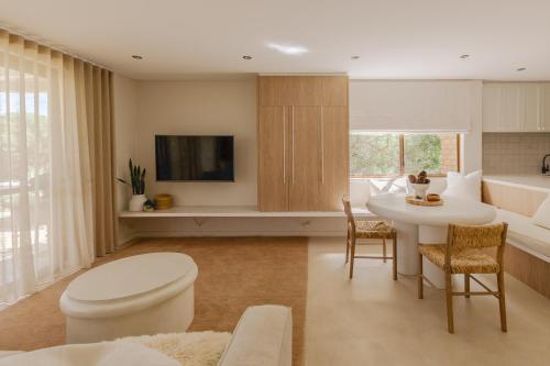a living room with a white table and a table and chairs at Scarborough Beach Retreat in Perth