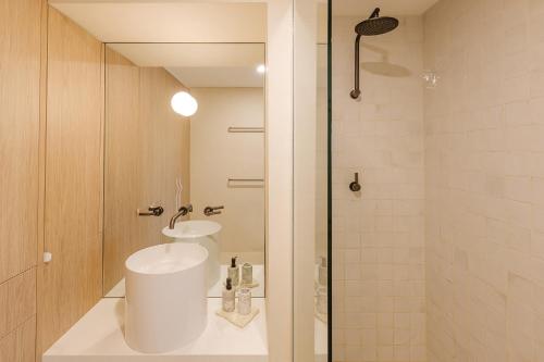 a bathroom with a sink and a shower at Scarborough Beach Retreat in Perth