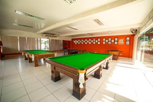 a room with two pool tables in it at Rota do Sol Apart Hotel in Guaratuba