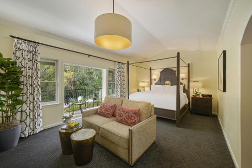 a bedroom with a bed and a couch and a chair at Fairmont Sonoma Mission Inn & Spa in Sonoma