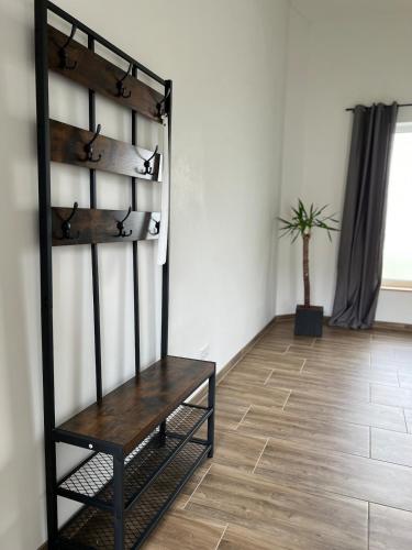 a wooden bench sitting in the corner of a room at NEUES appartment LOVE&LIGHT in Ollersdorf im Burgenland
