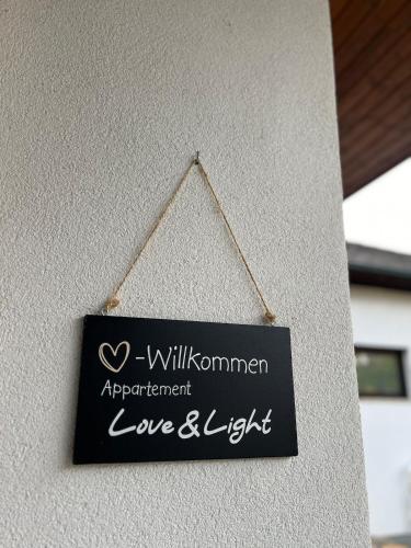 a sign on a wall that readslove and light at NEUES appartment LOVE&LIGHT in Ollersdorf im Burgenland