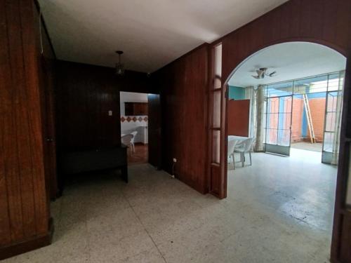 an empty room with a living room and a dining room at Hotel Los Ebanos in Piura