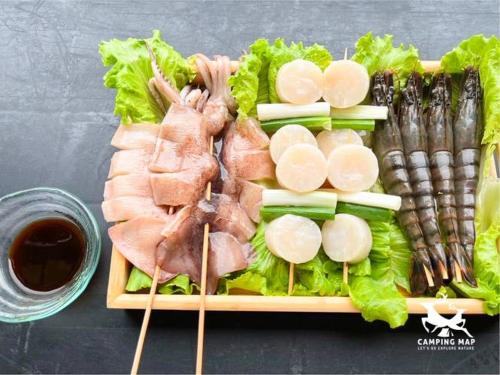 a plate of food with meat and lettuce and asparagus at 99Glamping in Douliu