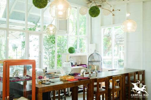 a kitchen with a table with a bird cage on it at 99Glamping in Douliu