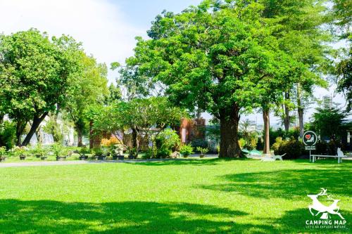 a park with trees and a green grass field at 99Glamping in Douliu