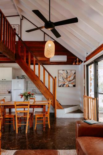 a dining room with a table and a ceiling fan at Cottage 3 - The Row in Forest Grove