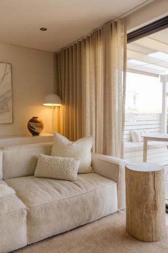 a living room with a couch and a table at Scarborough Beach Retreat in Perth