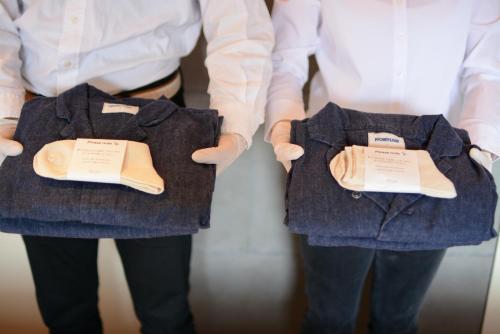 two people holding up two pieces of clothing in their hands at MINKA Riverside Villas in Imizu