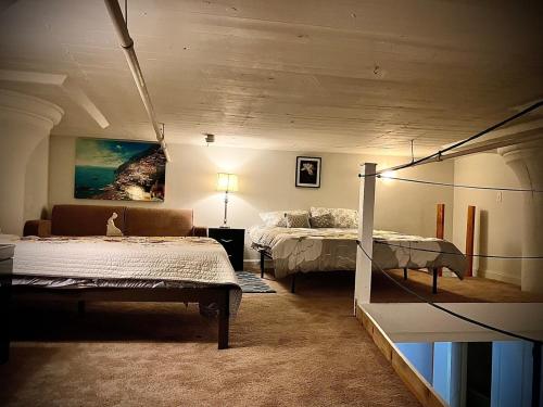 a bedroom with two beds and a couch in it at Downtown Riverview Loft in Detroit